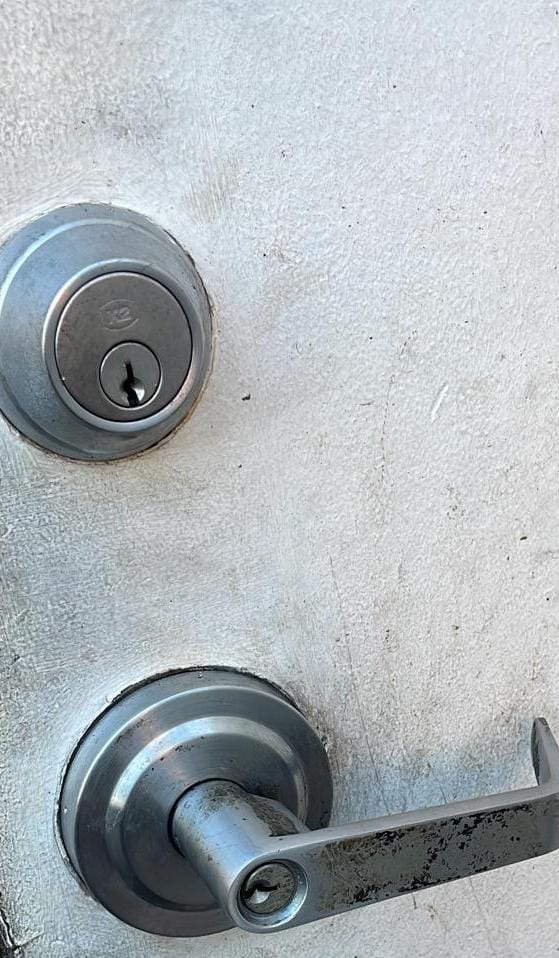 Commercial deadbolt and lever handle installed on a business door