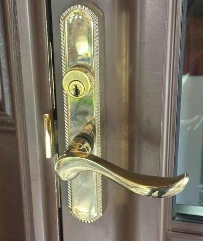 Decorative brass door handle and mortise lock after repair
