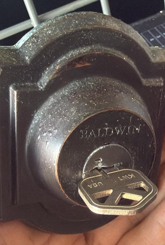 Baldwin deadbolt with a KW1 key in the cylinder