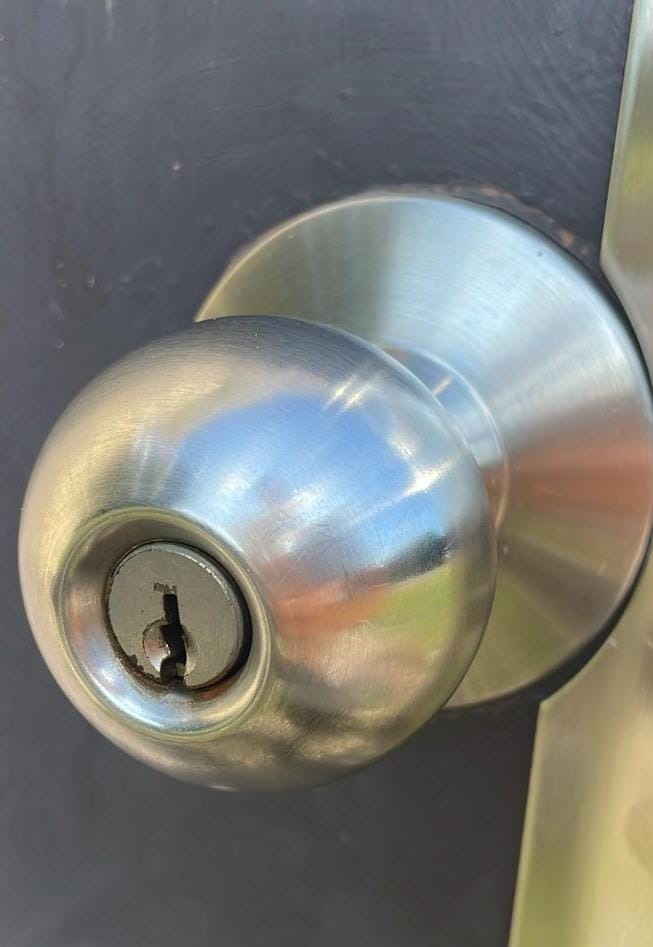 Commercial door knob installed with a latch guard plate