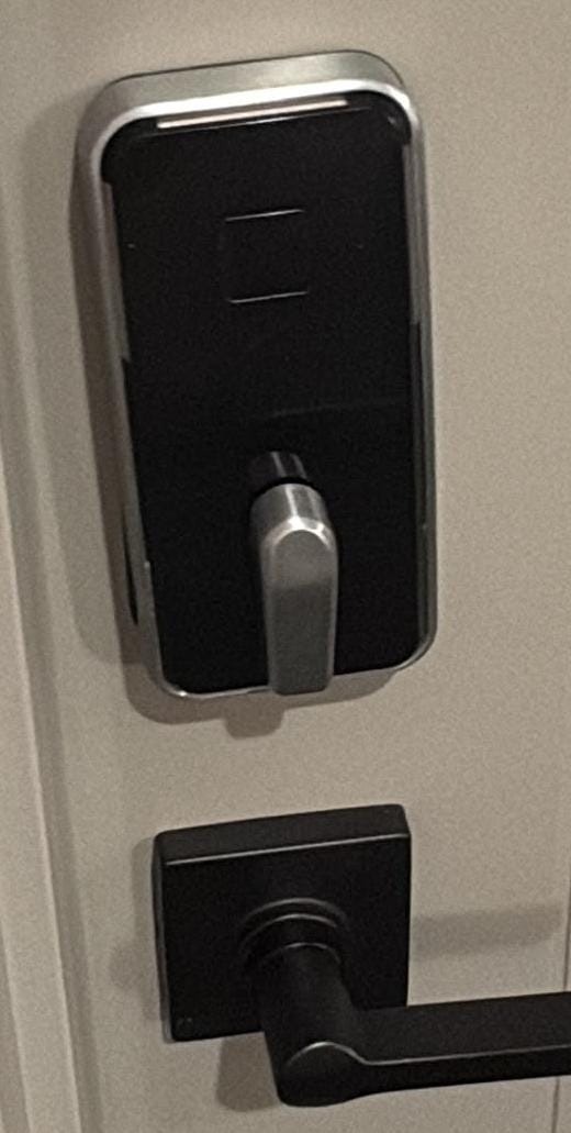 New smart lock and lever handle installed on a door