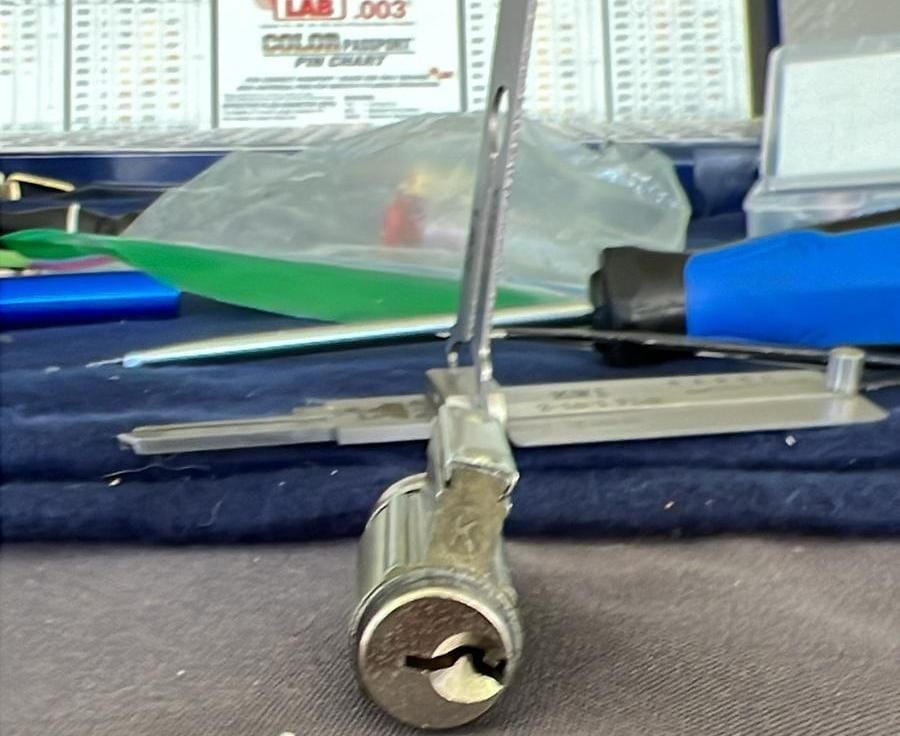 Lock cylinder being rekeyed on a workbench