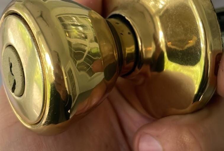 Brass door knob removed from a door to be rekeyed